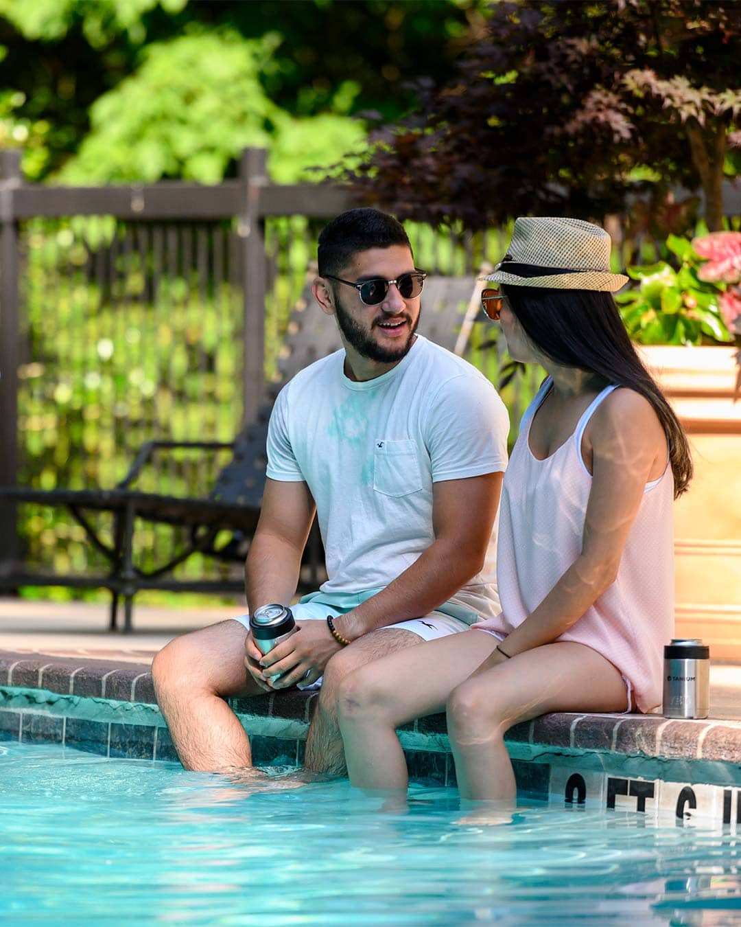 couple sitting by pool